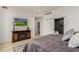 Comfortable bedroom featuring a TV, modern decor, walk-in closet, and ensuite bathroom access at 1401 Delgany St # 204, Denver, CO 80202