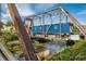 Bridge over the stream with greenery, blue shipping container and sunny sky at 1401 Delgany St # 204, Denver, CO 80202