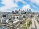 Expansive cityscape view with modern buildings, a river, and lush green spaces under a partly cloudy sky at 1401 Delgany St # 204, Denver, CO 80202