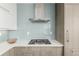 Close-up of a modern kitchen featuring stainless steel appliances, light blue backsplash, and sleek countertops at 1401 Delgany St # 204, Denver, CO 80202