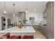 Modern kitchen with stainless steel appliances, a large island, and stylish pendant lighting creates a bright and welcoming space at 1401 Delgany St # 204, Denver, CO 80202
