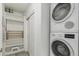 Functional laundry room with stacked washer and dryer, storage shelves, and easy access at 1401 Delgany St # 204, Denver, CO 80202