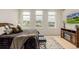 Bright and inviting main bedroom featuring multiple windows for city views and stylish furnishings for comfort at 1401 Delgany St # 204, Denver, CO 80202