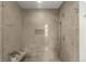 Glass enclosed shower with light stone style tiling, a built-in niche and a corner plant shelf at 1401 Delgany St # 204, Denver, CO 80202