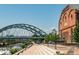 Picturesque street view featuring a bridge, riverfront pathway, and a historic brick building at 1401 Delgany St # 204, Denver, CO 80202