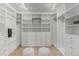 Spacious walk-in closet with custom shelving, drawers, and ample storage for clothes and accessories at 1401 Delgany St # 204, Denver, CO 80202