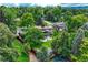 Aerial view of a home with large backyard, patio, and mature trees at 5 Hillside Dr, Wheat Ridge, CO 80215