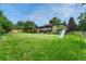 Spacious backyard with play structure, patio, and lush lawn at 5 Hillside Dr, Wheat Ridge, CO 80215