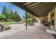Covered patio offering lounge seating, a fire pit, grill and easy access to the lush backyard at 5 Hillside Dr, Wheat Ridge, CO 80215