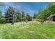 Large backyard with playground set and mature trees at 5 Hillside Dr, Wheat Ridge, CO 80215