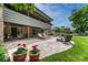 Beautiful outdoor space boasts a stone patio, lounge seating, a fire pit, and lush landscaping at 5 Hillside Dr, Wheat Ridge, CO 80215