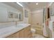 Bright bathroom featuring neutral walls, a large mirror and vanity, and a tub/shower combo at 5 Hillside Dr, Wheat Ridge, CO 80215
