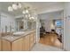 Bright bathroom featuring granite counters, modern lighting, a vessel sink, and an open doorway to the main bedroom at 5 Hillside Dr, Wheat Ridge, CO 80215