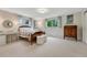 Bright bedroom with windows, a writing desk, and a cozy bed with a unique quilt at 5 Hillside Dr, Wheat Ridge, CO 80215