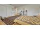 Neutral bedroom featuring warm wood floors, white walls, a double closet, and simple decor at 5 Hillside Dr, Wheat Ridge, CO 80215