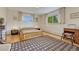 Cozy bedroom featuring warm wood floors, neutral walls, bright windows and a stylish area rug at 5 Hillside Dr, Wheat Ridge, CO 80215