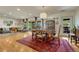 Open concept dining area with hardwood floors, stylish furnishings, and access to the outdoors at 5 Hillside Dr, Wheat Ridge, CO 80215