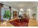 Charming dining area with hardwood floors, decorative rug, and ample natural light at 5 Hillside Dr, Wheat Ridge, CO 80215