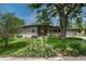 Charming gray single-story home featuring a lush front yard and manicured landscaping at 5 Hillside Dr, Wheat Ridge, CO 80215