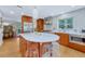 Updated kitchen with stainless steel appliances, hardwood cabinets, and a center island with seating at 5 Hillside Dr, Wheat Ridge, CO 80215