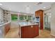 Gourmet kitchen with modern appliances, wood cabinetry, and a large island with seating at 5 Hillside Dr, Wheat Ridge, CO 80215