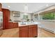Well-lit kitchen with stainless steel appliances, a center island, and wood cabinets at 5 Hillside Dr, Wheat Ridge, CO 80215