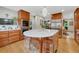 Bright kitchen with a large island, stainless appliances, and hardwood floors throughout at 5 Hillside Dr, Wheat Ridge, CO 80215