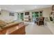Open living room featuring neutral decor, a cozy leather armchair, and sliding glass doors to the backyard at 5 Hillside Dr, Wheat Ridge, CO 80215