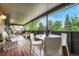 Covered patio with comfortable seating, dining area, and views of the surrounding greenery at 5 Hillside Dr, Wheat Ridge, CO 80215