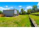 Large backyard with a terraced garden, lush lawn, privacy fence, and exterior view of the home at 16322 E Idaho Pl, Aurora, CO 80017