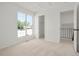 Bright, airy bedroom with a large window and neutral carpet flooring; closet entry visible at 16322 E Idaho Pl, Aurora, CO 80017