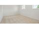 Bright, carpeted bedroom with two windows offering natural light and ventilation at 16322 E Idaho Pl, Aurora, CO 80017