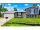 Charming gray home featuring a well-maintained lawn and complemented by a mailbox and garage door at 16322 E Idaho Pl, Aurora, CO 80017