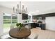 Cozy kitchen with stainless steel appliances, dark cabinetry, and view of backyard from dining area at 16322 E Idaho Pl, Aurora, CO 80017