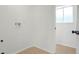 Laundry room features tile flooring, natural light, and washer/dryer hookups at 16322 E Idaho Pl, Aurora, CO 80017