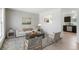 Bright living room featuring neutral decor, a decorative rug, comfortable seating, and natural light at 16322 E Idaho Pl, Aurora, CO 80017