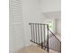 Modern staircase featuring black iron railings and bright white walls, illuminated by a window at 16322 E Idaho Pl, Aurora, CO 80017