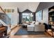 Stunning living room featuring hardwood floors, grey sectional, and dark accent wall at 18986 E Progress Ln, Centennial, CO 80015