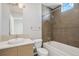 Bathroom featuring a vanity, toilet, and tub-shower combination with tiled walls at 2335 Walnut St # 10, Denver, CO 80205