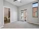Spacious bedroom with neutral carpet, ceiling fan, access to balcony, and a bathroom nearby at 2335 Walnut St # 10, Denver, CO 80205