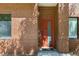 Close up of brick condo entrance with red door and modern windows at 2335 Walnut St # 10, Denver, CO 80205