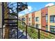 Exterior view from spiral staircase showing colorful condos with blue skies above at 2335 Walnut St # 10, Denver, CO 80205