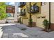 Exterior of attached homes with garages and small trees along a concrete drive at 2335 Walnut St # 10, Denver, CO 80205