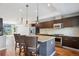 Bright kitchen with a large island, stainless appliances, and dark wood cabinets at 2335 Walnut St # 10, Denver, CO 80205
