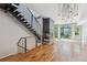 Open concept living room with hardwood floors, fireplace and stairway at 2335 Walnut St # 10, Denver, CO 80205