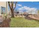 Expansive, well-maintained backyard with lush green lawn and mature trees, surrounded by a wooden fence at 2411 S Garfield St, Denver, CO 80210