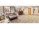 Wide view of finished basement with bar area and comfortable sofa at 2411 S Garfield St, Denver, CO 80210