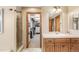 A bathroom with a sink, shower, and an open doorway to a large walk-in closet at 2411 S Garfield St, Denver, CO 80210