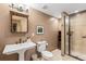 Bathroom featuring a sink, toilet, and glass enclosed shower stall at 2411 S Garfield St, Denver, CO 80210