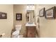 Charming powder room with framed art and a pedestal sink at 2411 S Garfield St, Denver, CO 80210